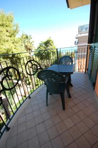 a patio with a table and chairs on a balcony at Residence Zodiaco in San Benedetto del Tronto