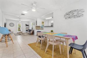 a kitchen and dining room with a table and chairs at Fun Get Togethers at the Beach! in St. Pete Beach