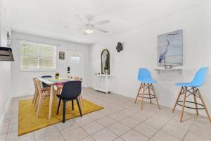 a living room with a table and blue chairs at Fun Get Togethers at the Beach! in St Pete Beach