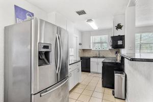 a large kitchen with a stainless steel refrigerator at Fun Get Togethers at the Beach! in St. Pete Beach