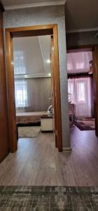 an open door to a room with a bed at Апартаменты на СОВЕТСКОЙ 39 in Petropavlovsk
