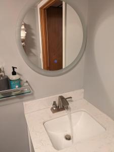 a bathroom with a sink and a mirror at ECLIPSE Vermont in Colchester
