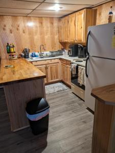 a kitchen with wooden cabinets and a refrigerator at ECLIPSE Vermont in Colchester
