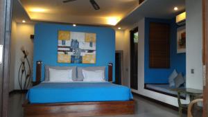 A bed or beds in a room at Amarta Beach Cottages