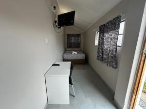 a small room with a white desk and a chair at Southernwood nest in East London