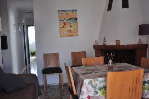 a dining room with a table and chairs and a fireplace at APARTAMENTO 3 PAUPÍ in Oliva