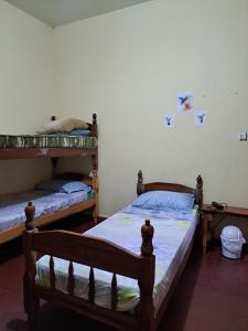 a bedroom with two bunk beds in a room at Hummingbird Hostel in Ciudad del Este