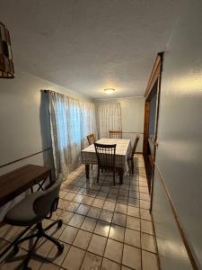 a dining room with a table and chairs in a room at Comfy getaway at falls! in Niagara Falls