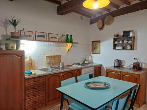 a kitchen with a table and a sink and a table and chairs at casa il Girasole Pitigliano in Pitigliano