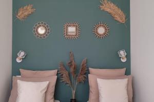 a bedroom with a blue wall with four mirrors at Maison cosy terrasse ensoleillé in Clermont-Ferrand