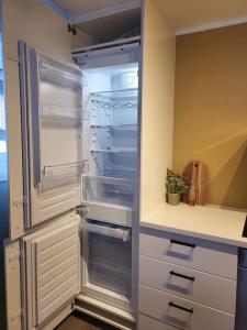 a refrigerator with its door open in a kitchen at Flott leilighet midt blant Lyngsalpene! in Lyngseidet
