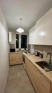 a kitchen with white cabinets and a sink at Rooms in Warsaw in Warsaw