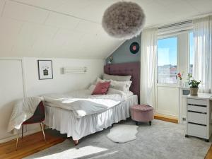 a bedroom with a bed and a large window at Lysekil sunset Villa in Lysekil