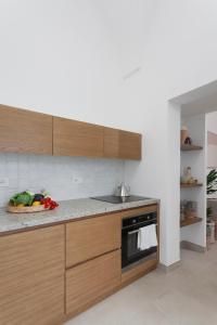 a kitchen with wooden cabinets and a counter top at Casa Shirocco in Ruffano
