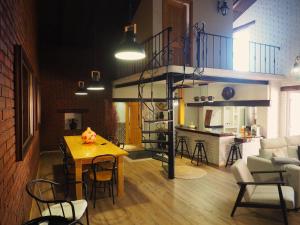 a room with a loft bed and a table and chairs at Casa da Venda do Marco in Caldas da Rainha +7 photos