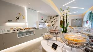 a bakery with bowls of food on display in a store at Dependance Pesce d'Oro in Verbania