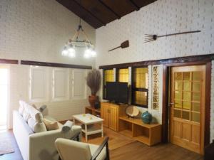 a living room with a couch and a tv at Casa da Venda do Marco in Caldas da Rainha