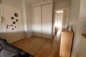 an empty living room with a room with a door at Simplicité et calme en appartement à Issoire in Issoire