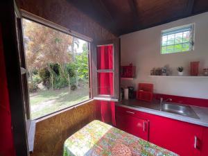 a small kitchen with a sink and a window at Eden Créole in Trois-Rivières