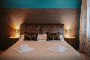 a bedroom with a large bed with two pillows on it at La Luce di Sirmione in Sirmione