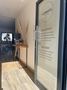 a sliding glass door with a sign on it at Calmaria Guesthouse in Porto Covo