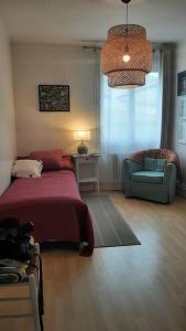 ein Schlafzimmer mit einem Bett und einem Stuhl und einem Fenster in der Unterkunft Flat with private parking, in the heart of Sete in Sète