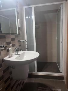 a bathroom with a white sink and a shower at Twenty Antika in Birgu