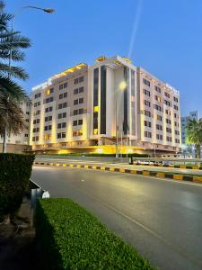 a large white building on the side of a street at Golden Tulip Muscat in Muscat