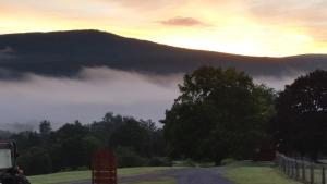 a foggy road with a view of a mountain at Clover Hill Farm & Country Inn in Williamstown