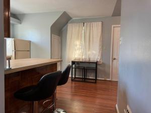 a kitchen with two chairs and a counter and a table at Comfy getaway full Apt single bedroom sleeps two! in Niagara Falls