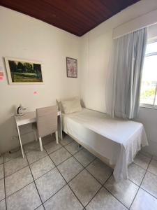 Ένα ή περισσότερα κρεβάτια σε δωμάτιο στο Quartos em Stella Maris