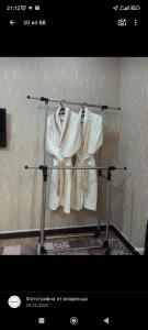 a rack with white clothes hanging on it at Отель Чынгыз 2 in Osh