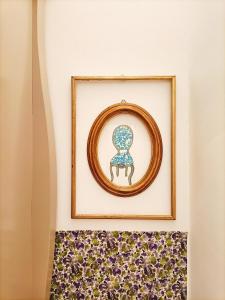 a picture of a chair in a frame on a wall at Festina Lente in Rome