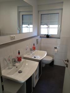 a bathroom with two sinks and a toilet at Bungalow 269 in Tossens in Tossenserdeich