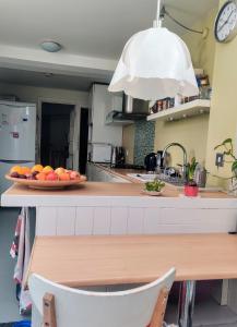 a kitchen with a plate of fruit on a counter at Headington Haven Homestay in Oxford