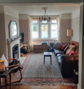 a living room with a couch and a fireplace at Headington Haven Homestay in Oxford