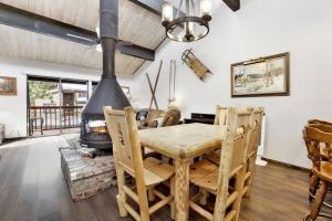 Un comedor con mesa y chimenea. en Smith Summit Chalet at Big Bear~ Base Camp Ski Condo~, en Big Bear Lake