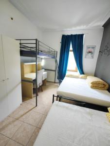 a bedroom with two bunk beds and a window at The ARK Eco Homestay in Esch-sur-Alzette