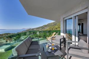 a living room with a couch and a table at Exclusive Penthouse Big Blue with private Jacuzzi in Makarska