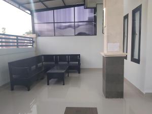 a group of benches in a room with a window at Chandra's house in Pesanggaran