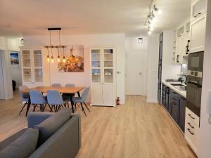 a kitchen and dining room with a table and chairs at Moonshine Érd in Érd
