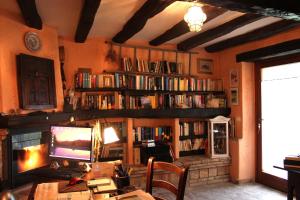 a room with a desk with a computer and book shelves at Country House Il Biroccio in Urbino
