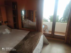 a bedroom with a bed and a view of a balcony at Bramer 6 Canyelles in Roses