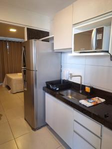 a kitchen with a stainless steel refrigerator and a sink at Beach Class Ilha Do Leite 3206 in Recife