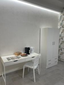 a white desk with a chair and a white cabinet at L'Ulivo in San Severo