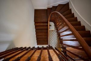 a staircase with wooden railings in a room at 1906 Citygarden in Chios