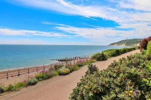 a path next to a beach with the ocean at City Escape with a Touch of Class in Eastbourne