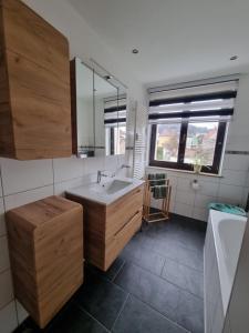 a bathroom with a sink and a mirror at Ferienwohnung Cumbach in Rudolstadt