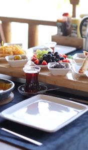 a table topped with plates and bowls of food at SEREN OTEL ÇEŞME in Cesme