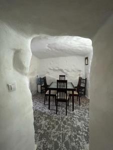 a dining room with a table and chairs in a cave at The Crystal Cave in Zújar
